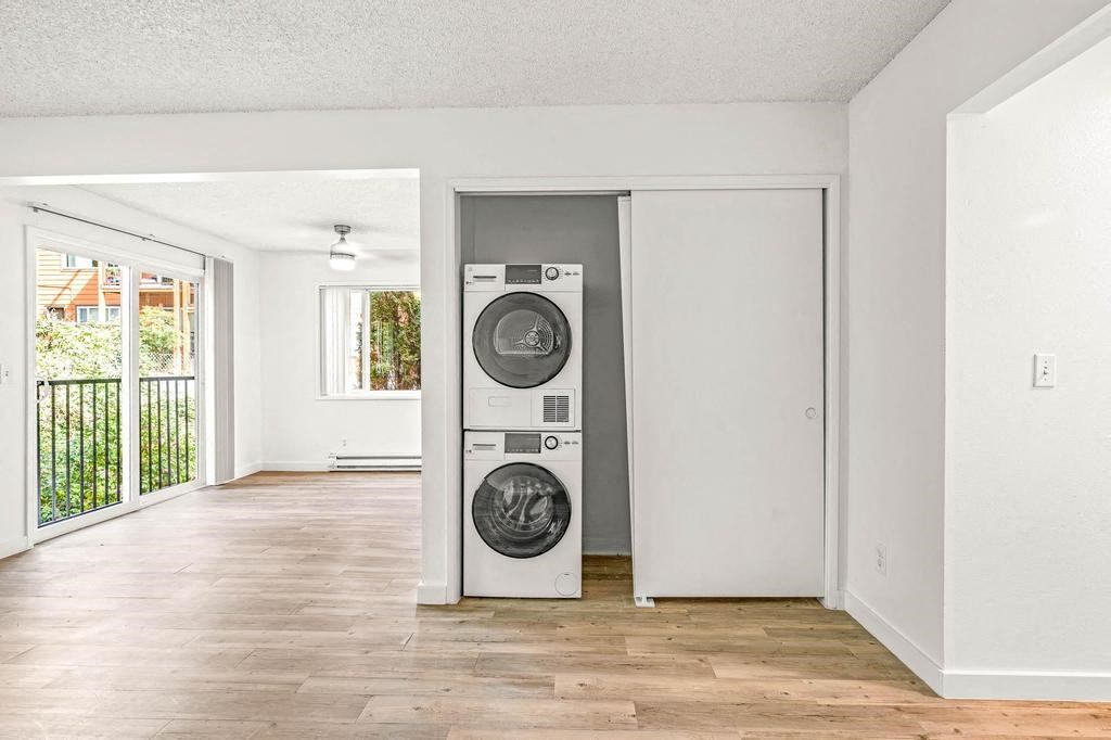 an empty room with a washer and dryer in it