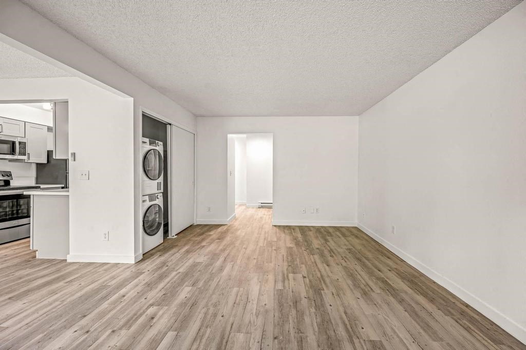 an empty room with a washer and dryer