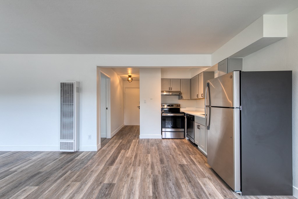 a kitchen with a refrigerator freezer and a stove top oven