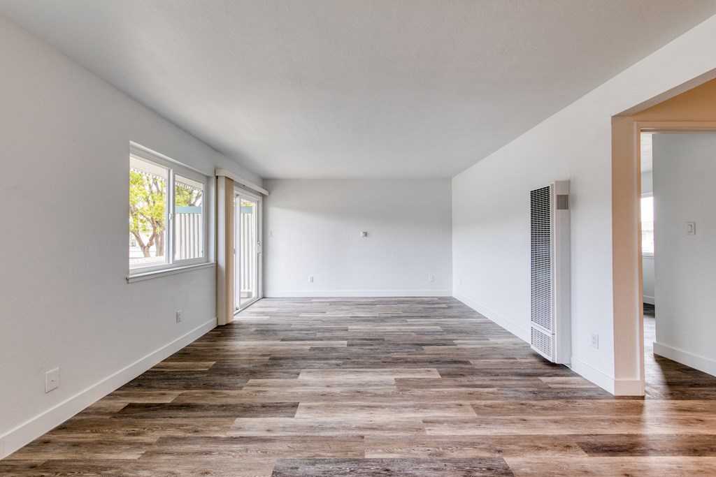 a bedroom with hardwood floors and grey walls