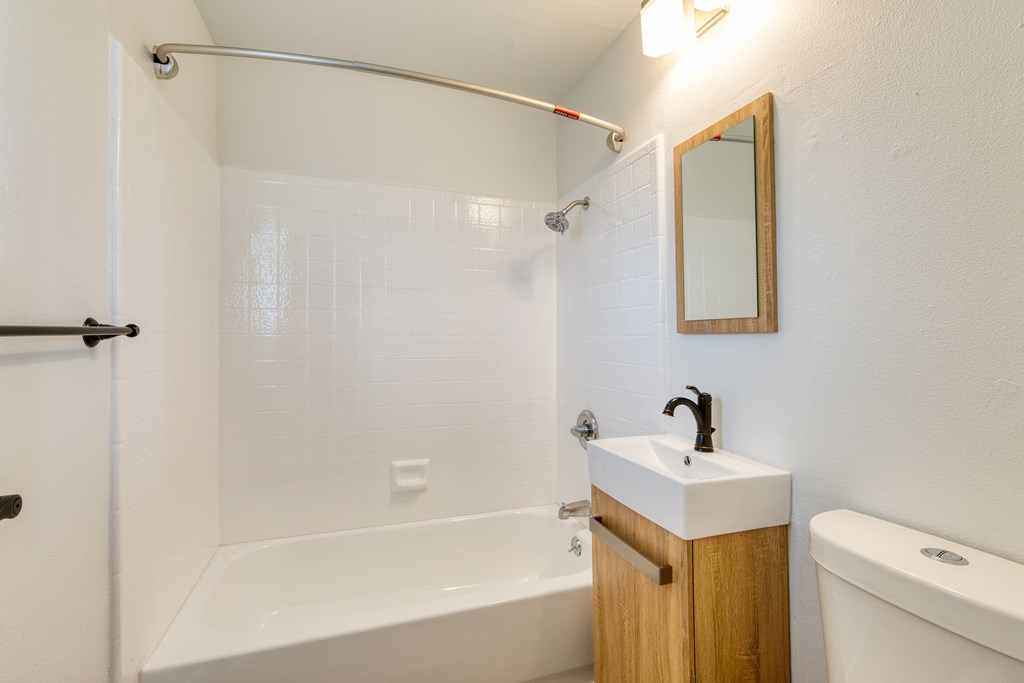 a bathroom with a sink toilet and bathtub