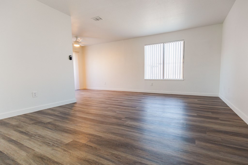 a bedroom with hardwood flooring at the oxford at estonia apartments in san an