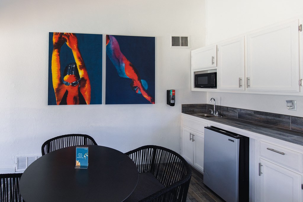 a kitchenette with a table and chairs