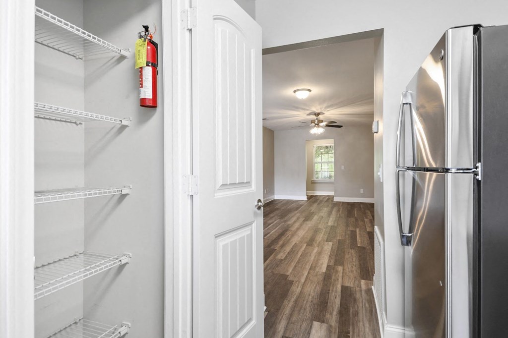 a kitchen with a refrigerator freezer next to a door