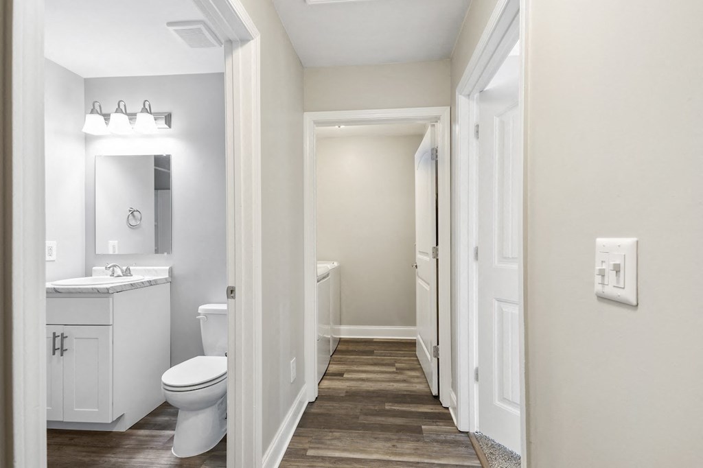 a bathroom with a toilet sink and mirror