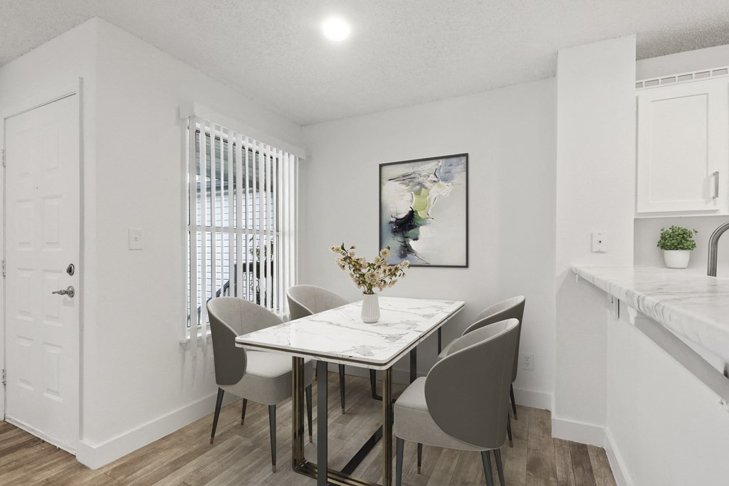 a dining room with a table and chairs