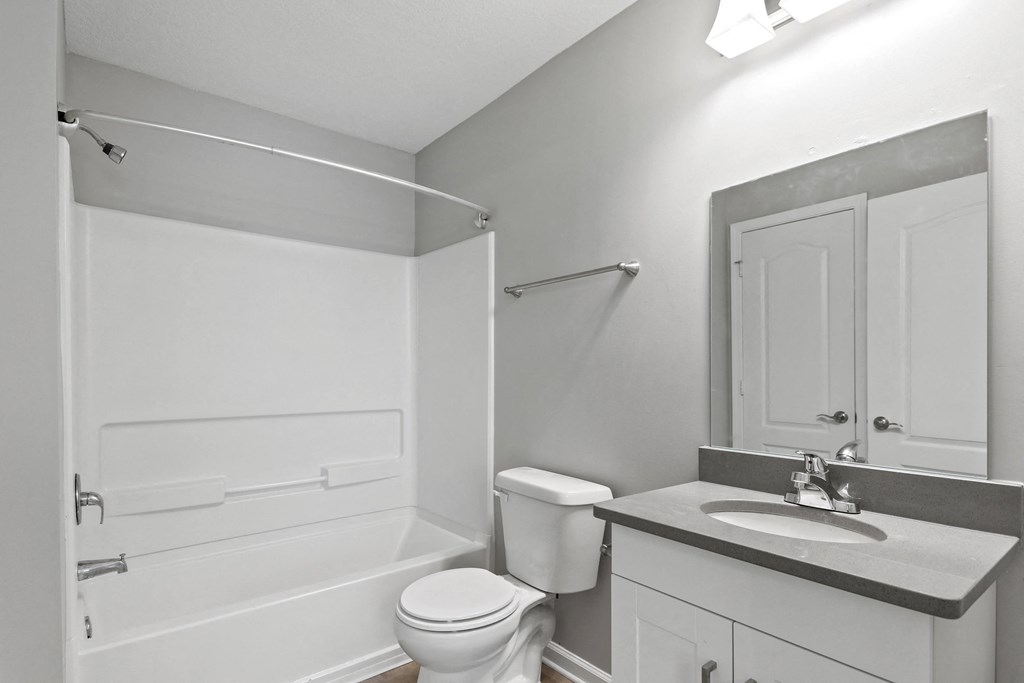 a bathroom with a sink toilet and a bath tub