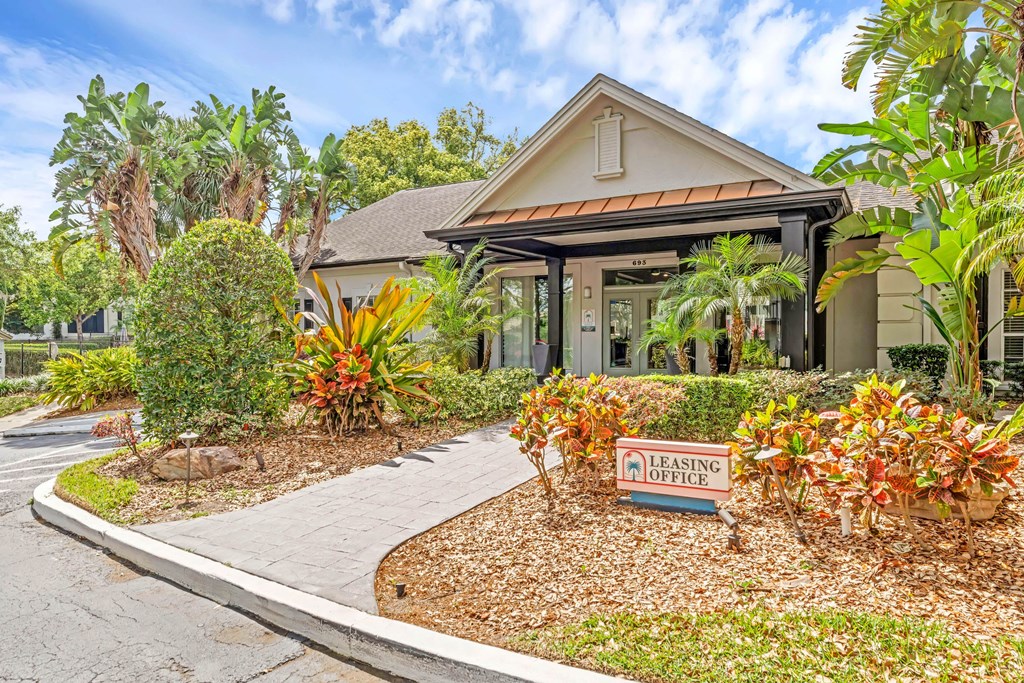 a bungalow with a sign in front of a house
