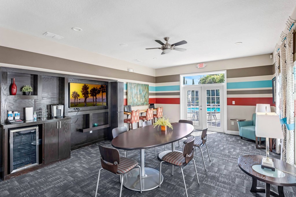 a living room with a table and chairs and a television