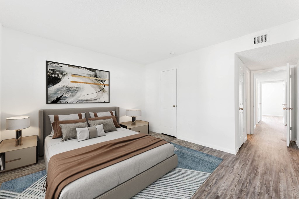 a bedroom with a large bed and a rug in front of a window