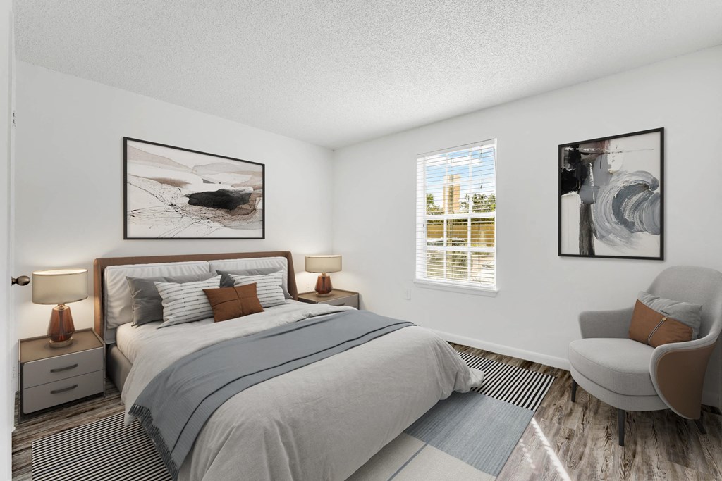 a bedroom with a bed and a chair in a 555 waverly unit