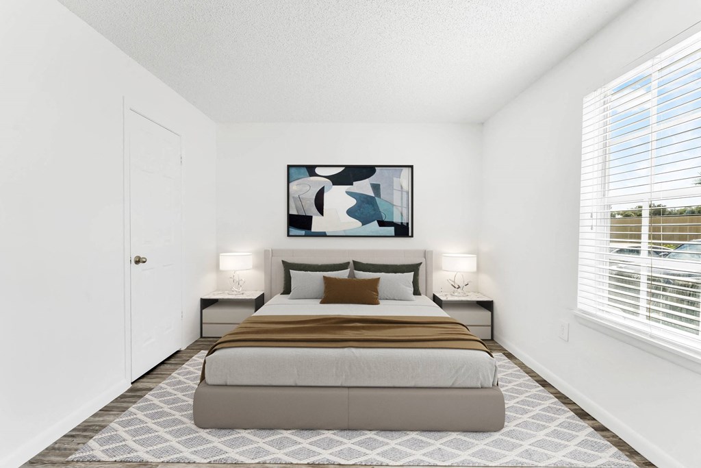 a bedroom with a large bed and a large window