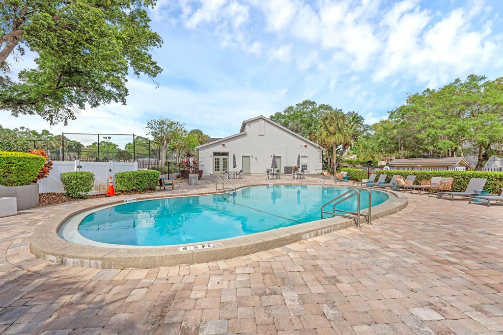 a swimming pool with a house in the background