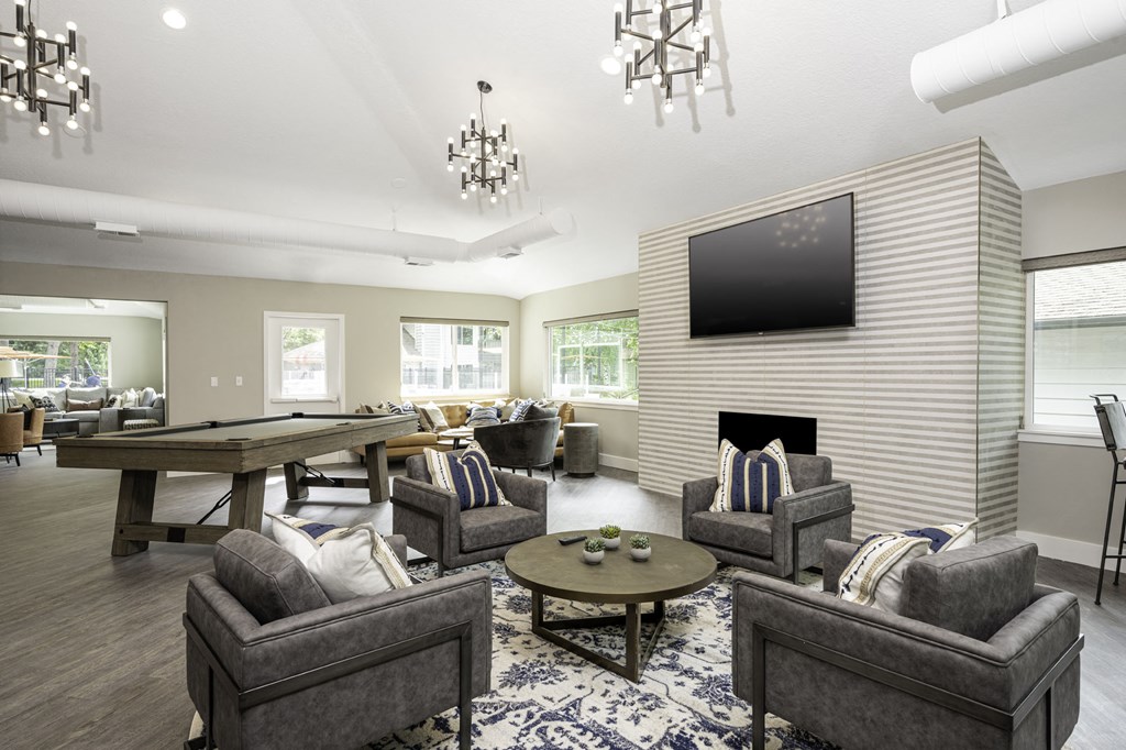 a resident clubhouse with a pool table and flat screen tv