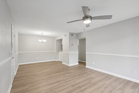 A room with a ceiling fan and light fixture.