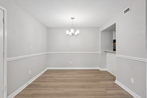 A room with wooden floors and white walls.