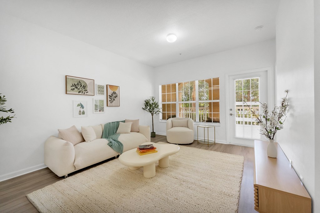 a living room with a white couch and a white coffee table
