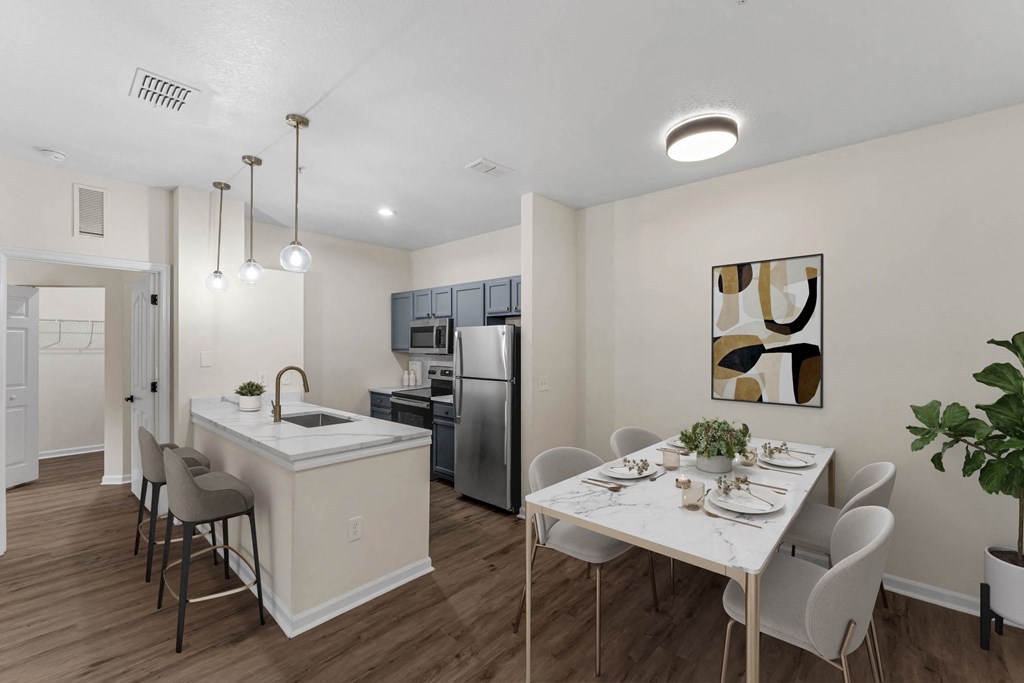 an open kitchen and dining room with a white table and chairs