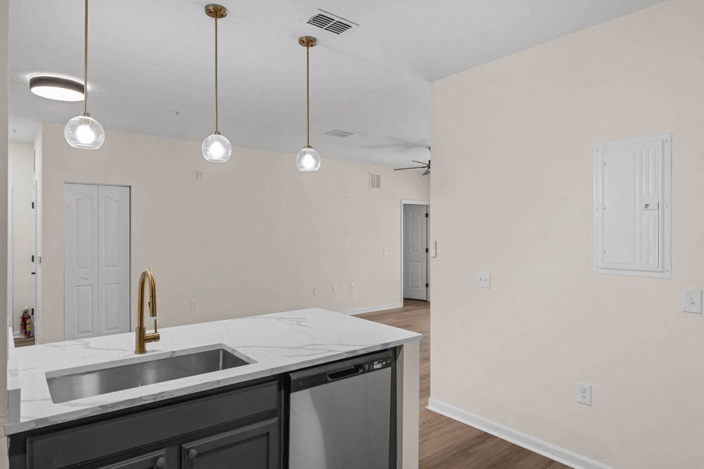 a kitchen with a sink and a window and a door