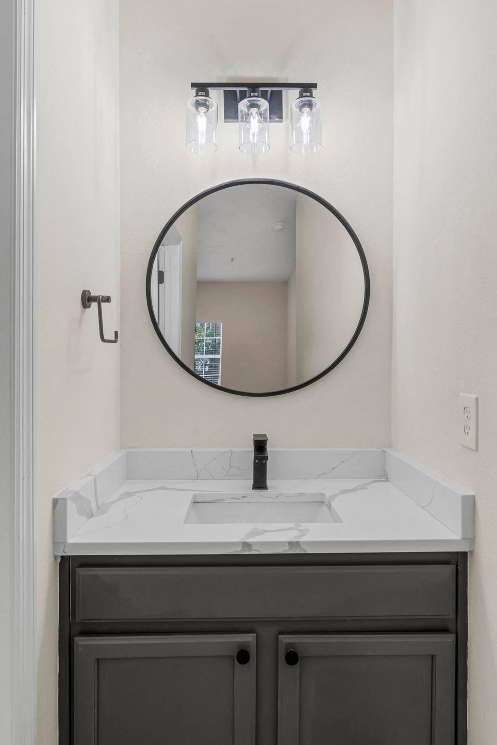 a small bathroom with a sink and a mirror