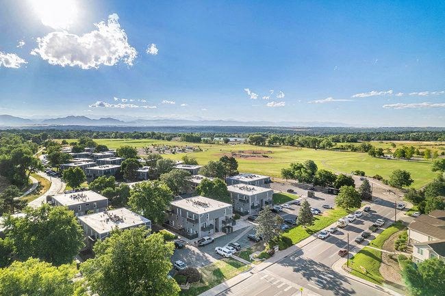 A sunny day at a residential complex with a clear blue sky.