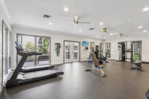 A gym with treadmills, exercise bikes, and other equipment.