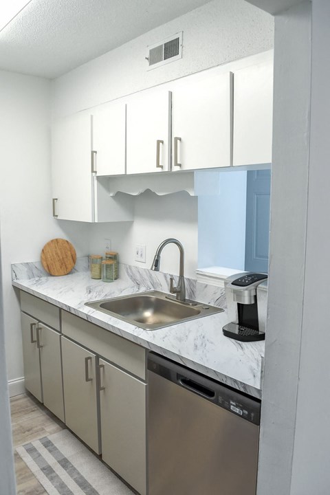 a kitchen with stainless steel appliances and white cabinets