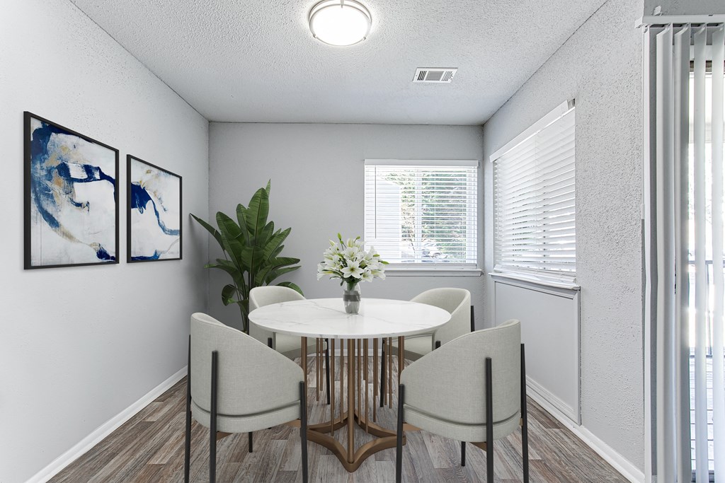 a dining room with a table and chairs