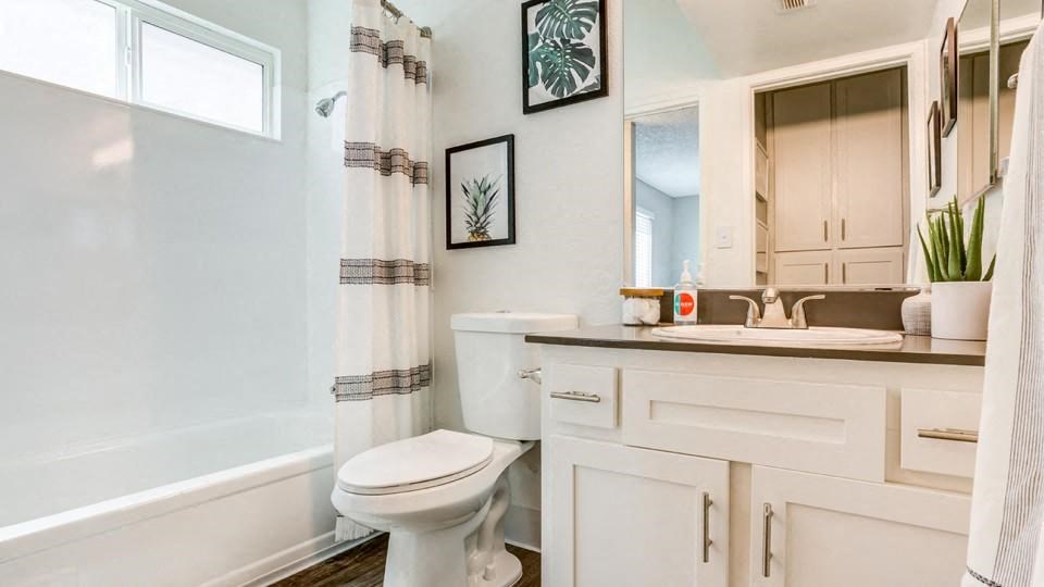 a bathroom with a toilet sink and bathtub
