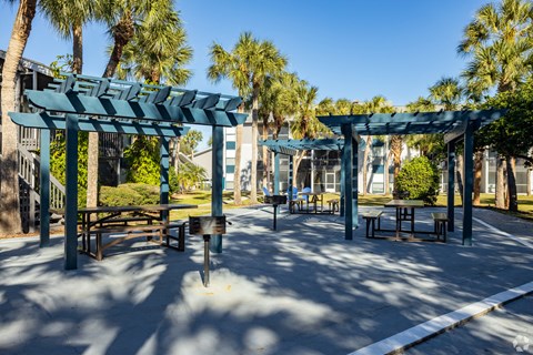a park with picnic tables and awnings