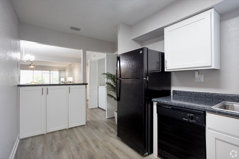 the preserve at ballantyne commons apartment kitchen and living room with black refrigerator