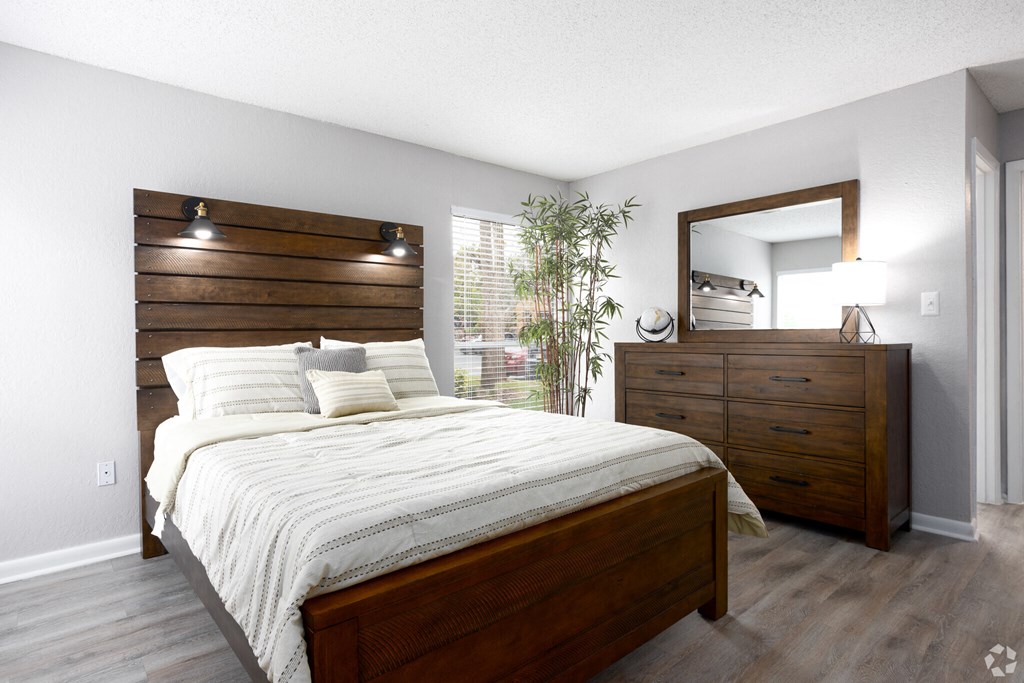 a bedroom with a bed and a dresser