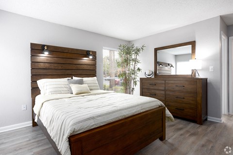 a bedroom with a bed and a dresser