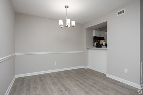 an empty living room with white walls and wood flooring