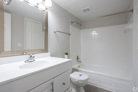 a bathroom with a sink toilet and a tub