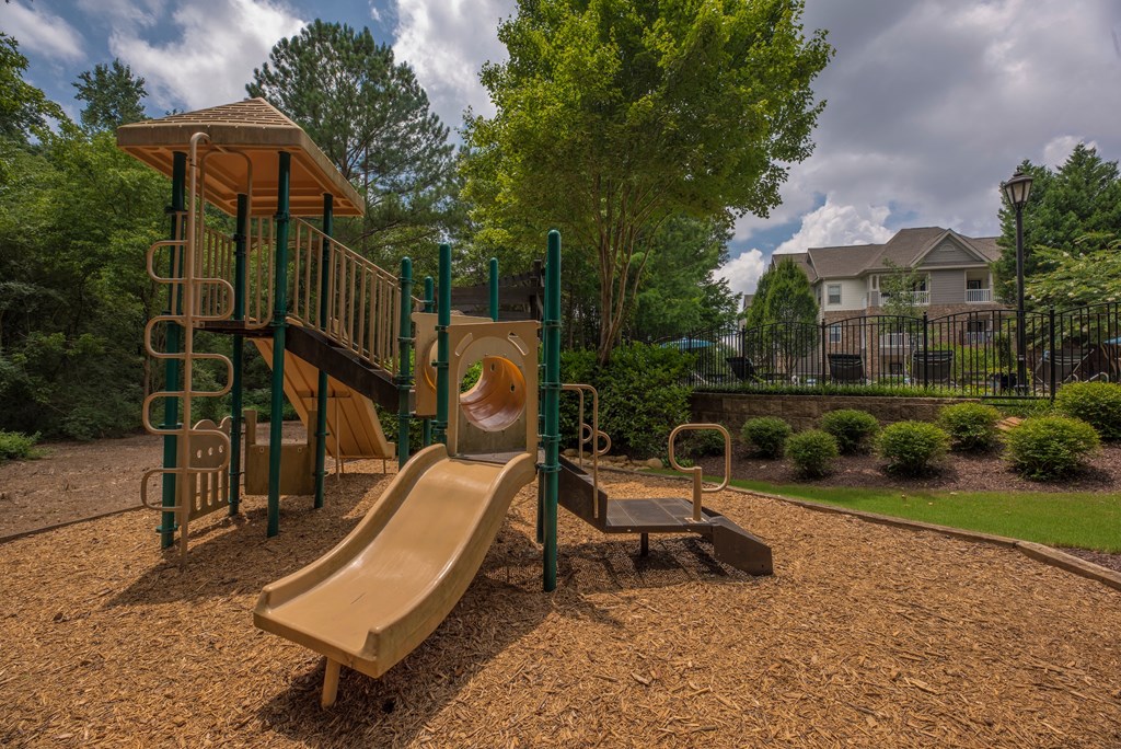 a playground with a slide and a swing set