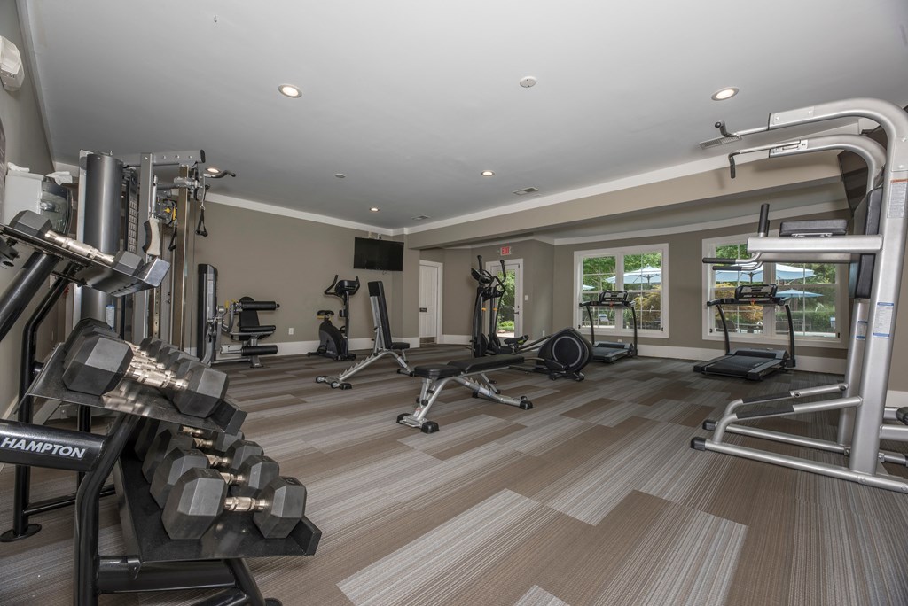 a gym with weights and cardio equipment in a home for sale