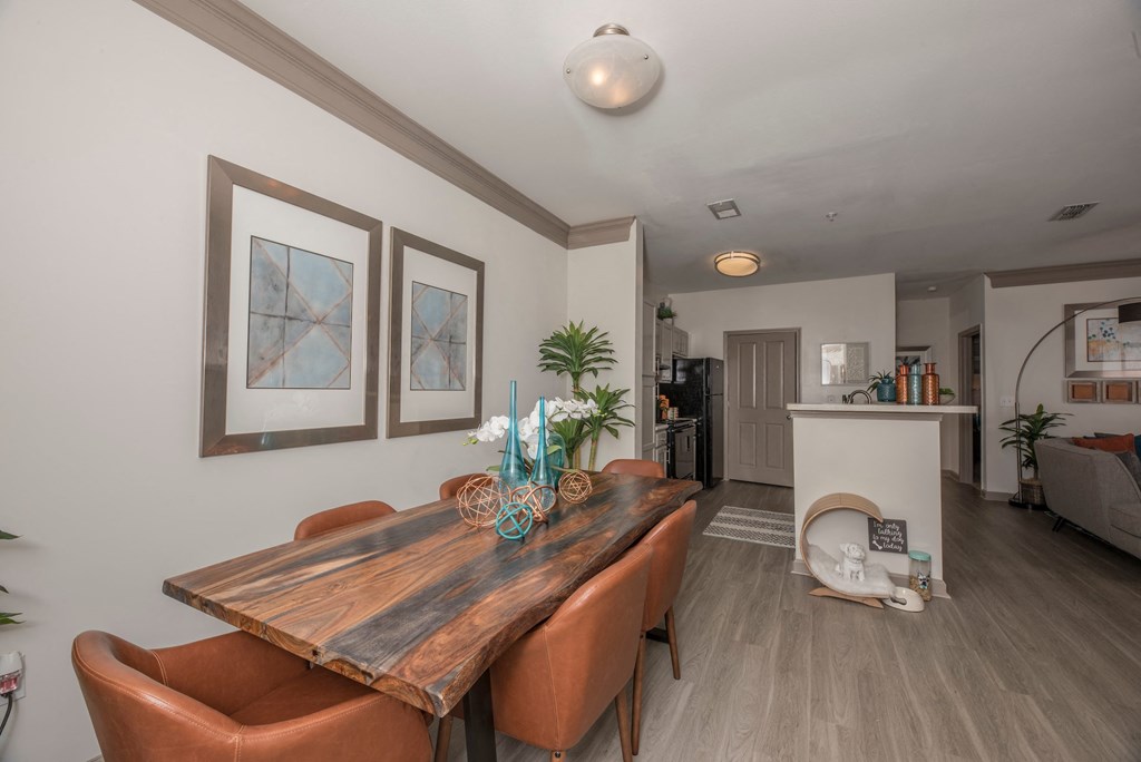 a dining room with a wooden table and leather chairs