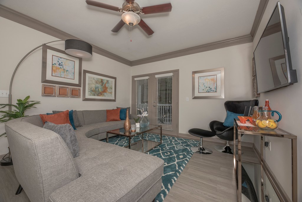 a living room with a couch and a ceiling fan