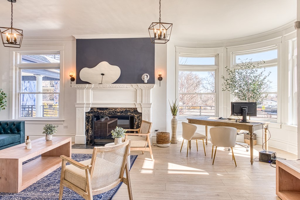 a living room with a fireplace and a large window