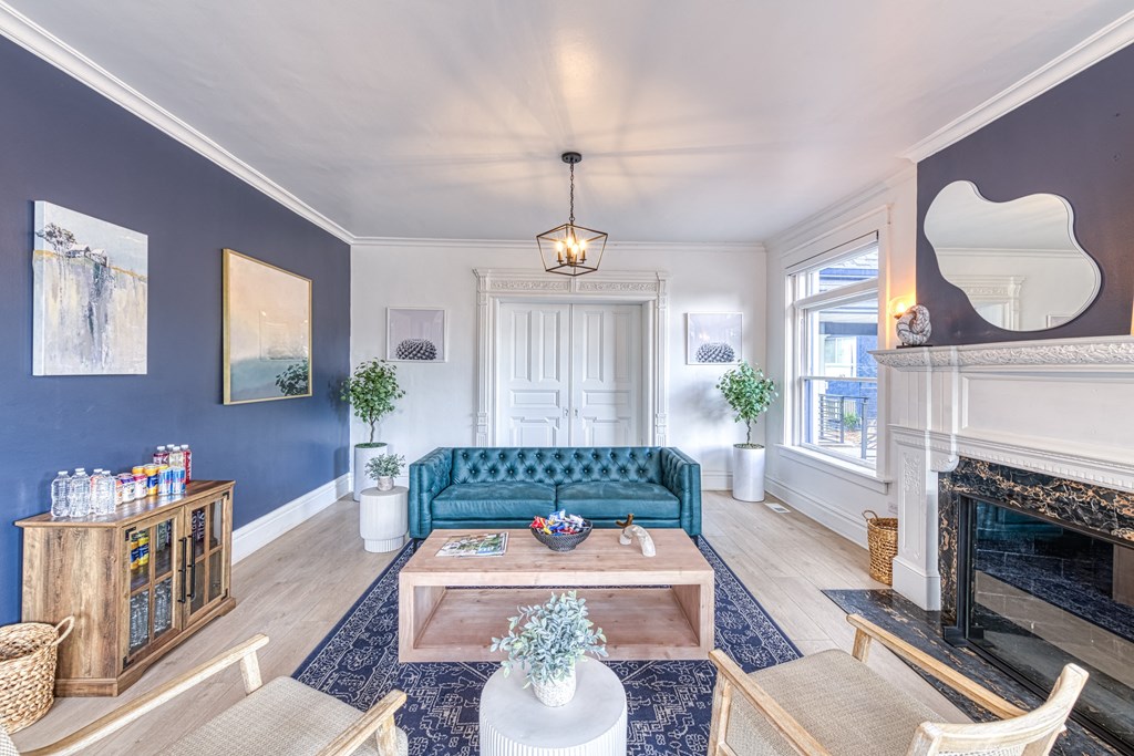 a living room with a blue couch and a fireplace