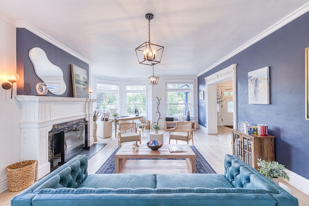 a living room with a blue couch and a fireplace