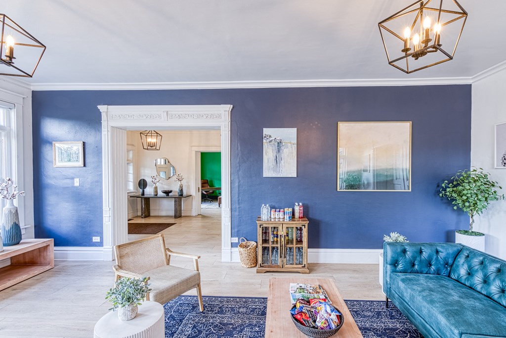 a living room with blue walls and a blue couch