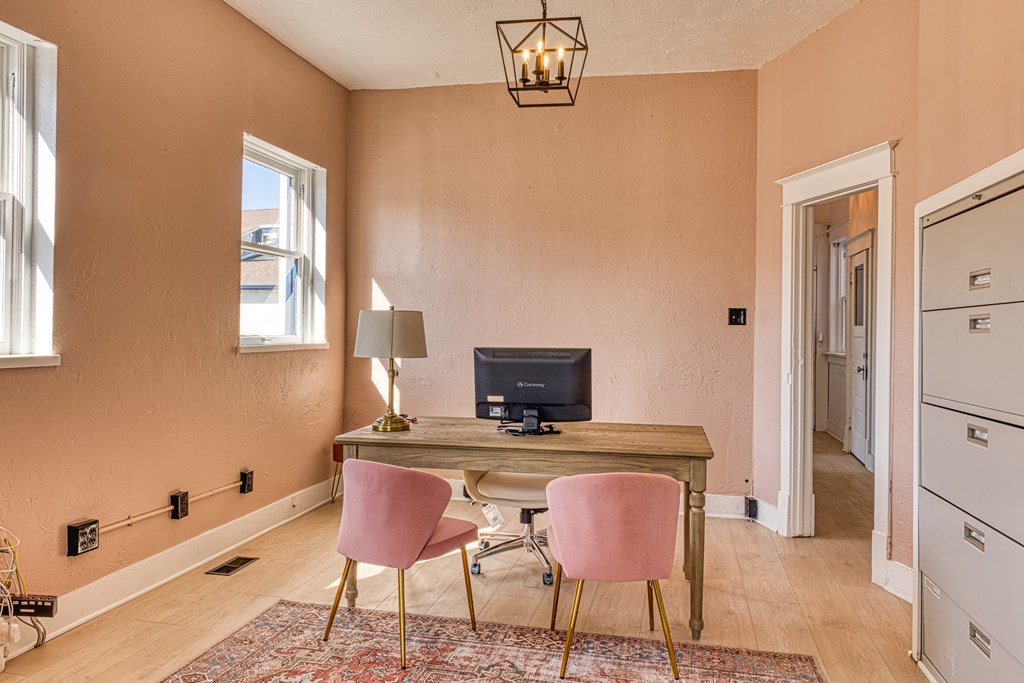 a home office with a desk and two chairs