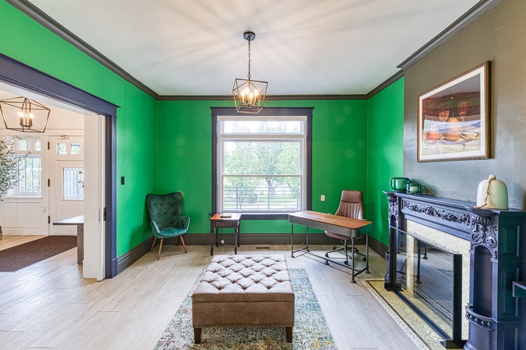 a living room with green walls and a fireplace