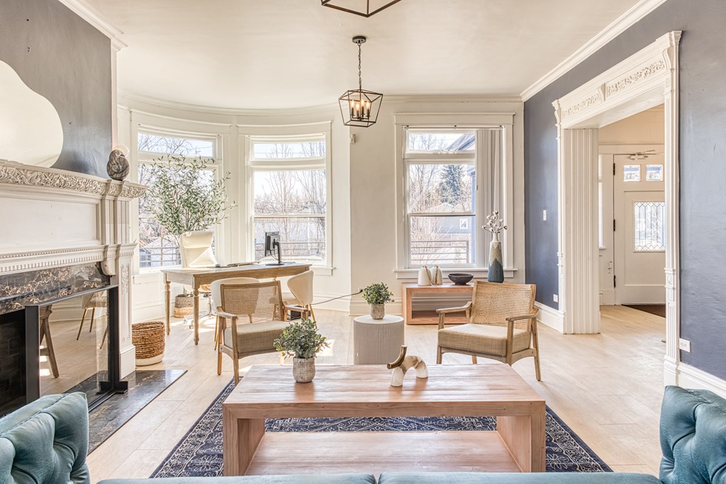 a living room with a fireplace and a large window