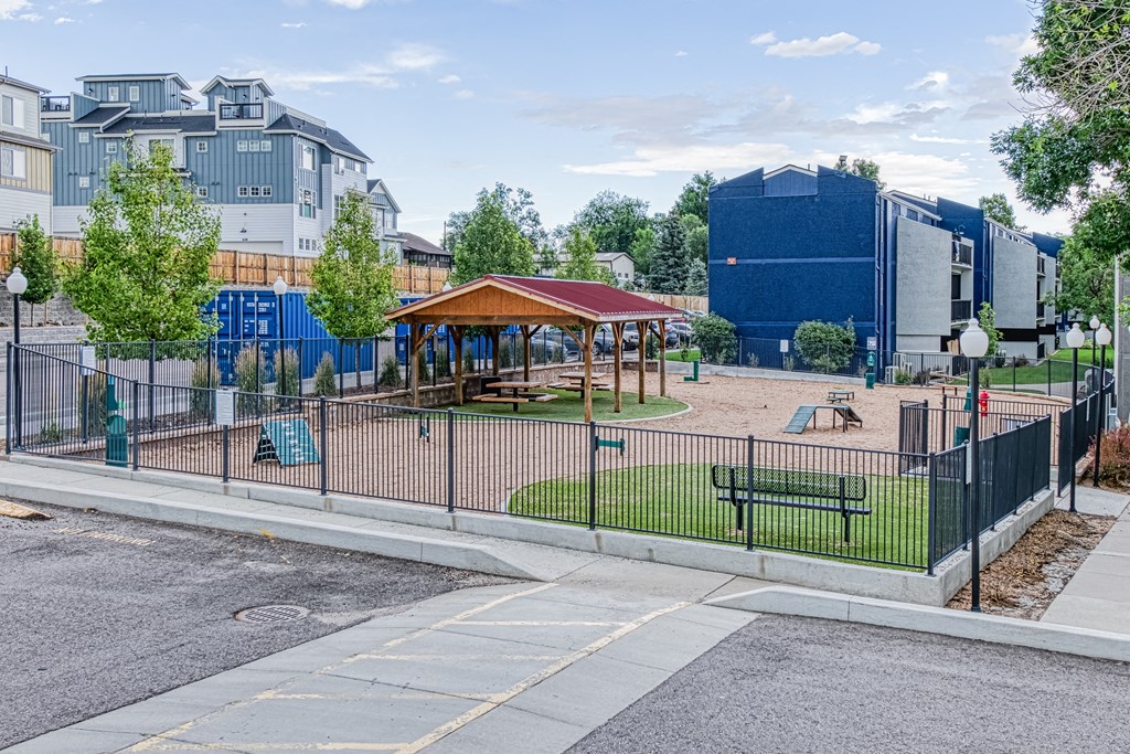 a park with a playground and a fence