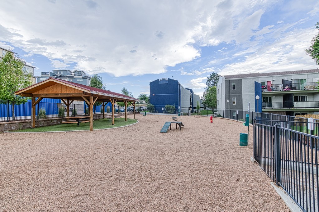 a playground with a pavilion and picnic table in a park