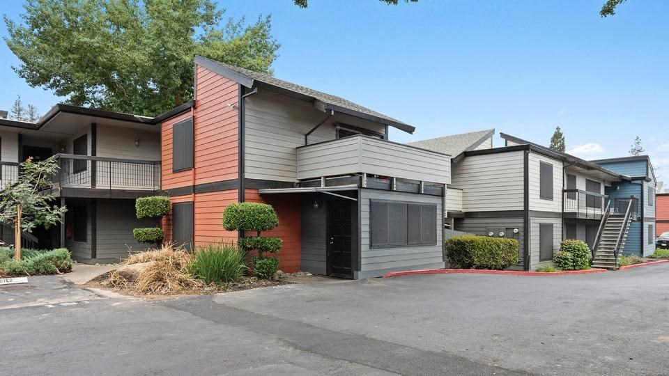 a building with a garage and a staircase in front of it