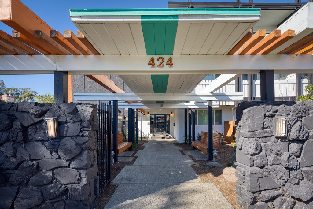 a view of the front of the building with stone walls and awnings